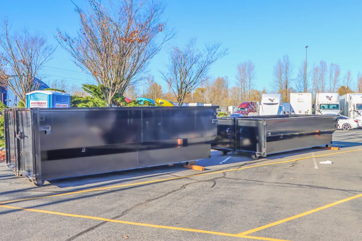 Professional dumpster rental service with roll-off container on residential driveway in Linton Hall